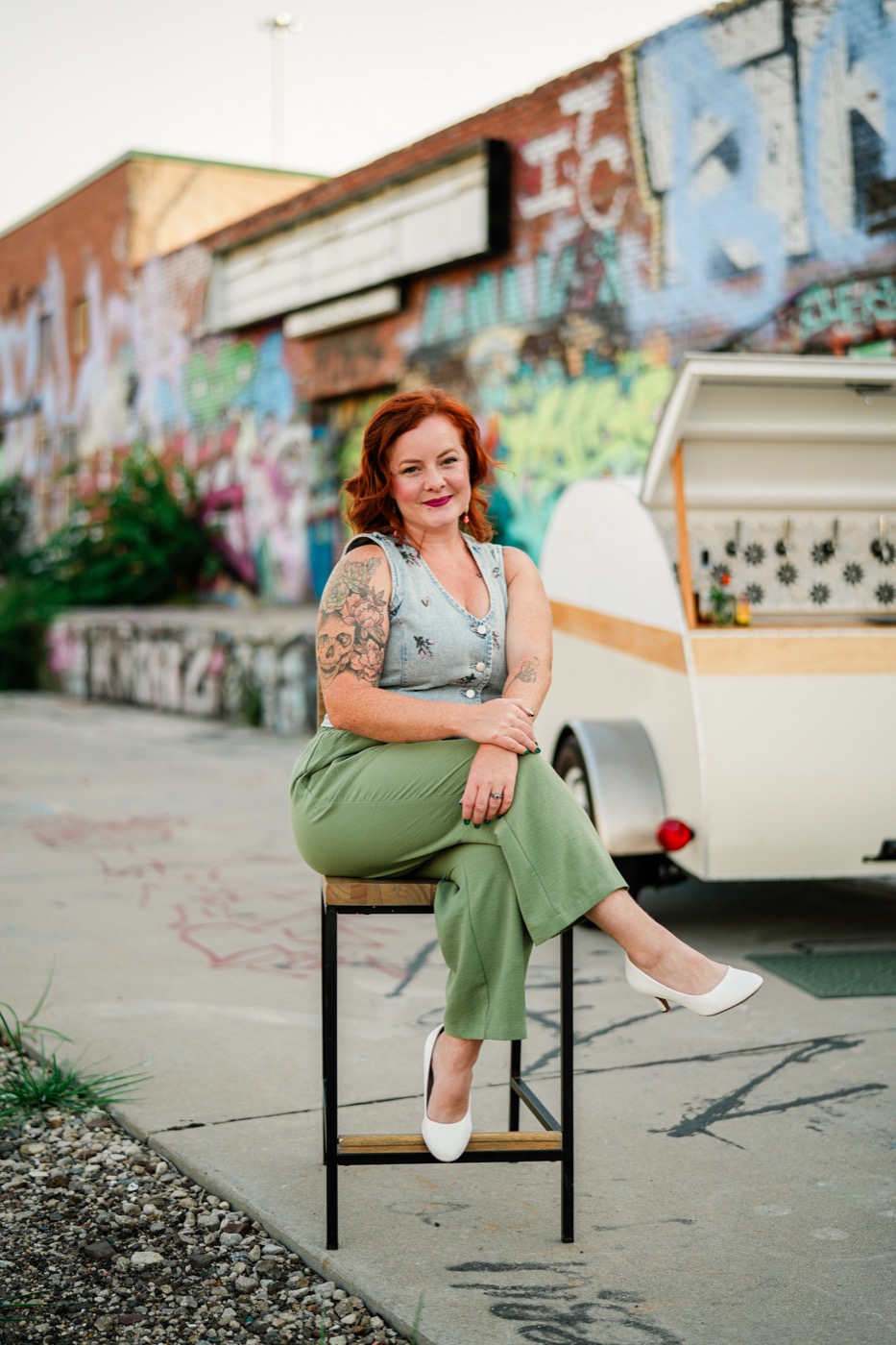 Aubre seated in front of the Bar 59 trailer on a Wichita street